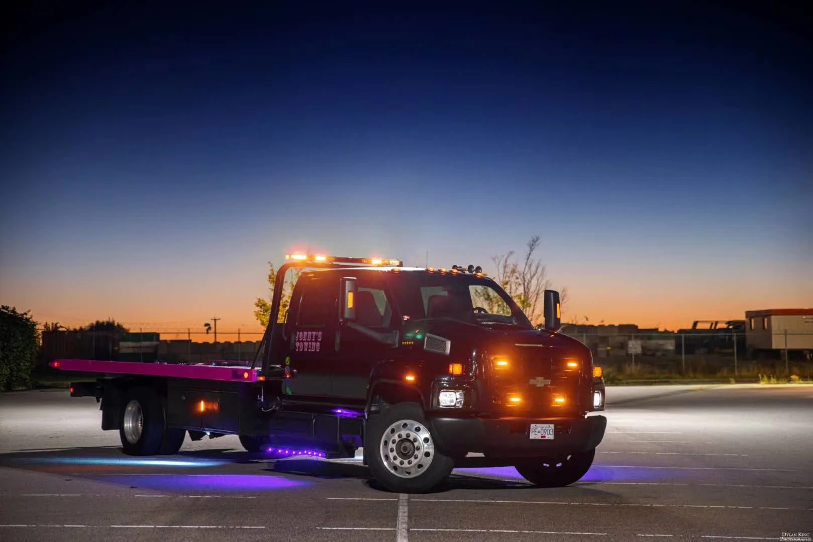 Jonny's Towing flatbed at sunset